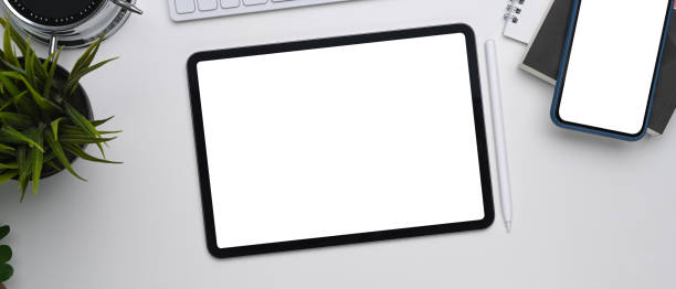 istock Top view of digital tablet and smart phone with empty screen on white table. 1309014963