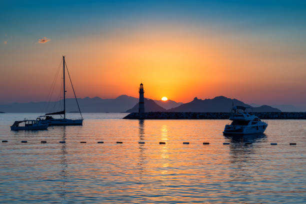 Islands in the Mediterranean Sea and a lighthouse at sunset in Bodrum, Turkey.