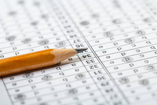 istock testing in exercise and exam paper. computer sheet with pencil in school test room, education concept 1309017602