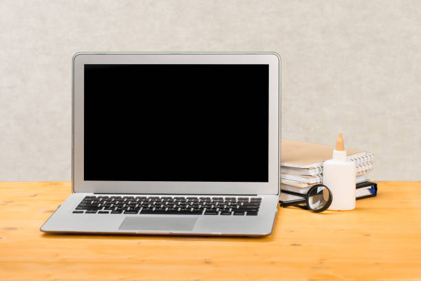 istock mocap Notebook with notebooks and stationery on a wooden table. 1309017778