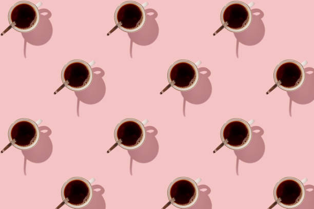 istock Mug of black coffee on a pink background. With a hard black shadow. Pattern. 1309017811