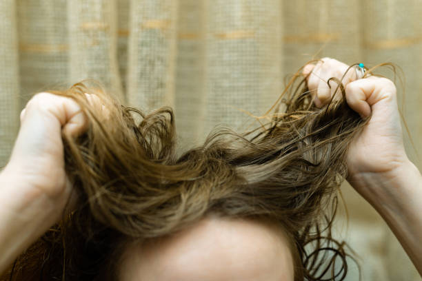 istock Mess, problem hair. Woman holding tangled hair in her hands. 1309019694