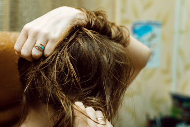 istock Mess, problem hair. Woman holding tangled hair in her hands. 1309019703