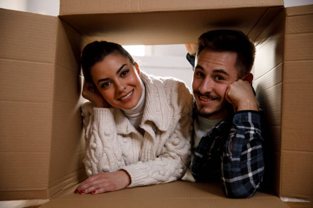 istock Couple lying inside the box and smiling at camera 1309020920