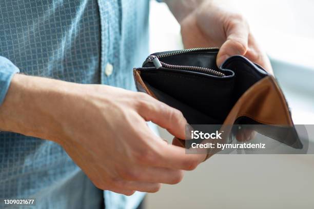 Holding In Hands Empty Wallet Stock Photo - Download Image Now - Empty Wallet, Change Purse, Wallet