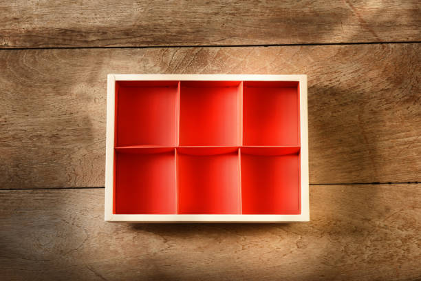 Top view of empty open red cardboard box on wooden background