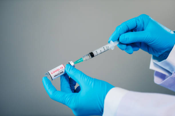 istock hand drawing Coronavirus (Covid-19) vaccine bottle into syringe injection medicine 1309026346