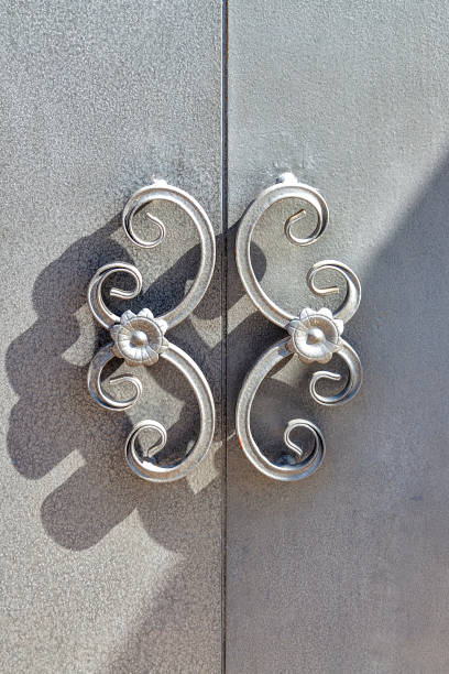 Door handles on the cupboard doors. Gray. Sunny autumn day. Front view.