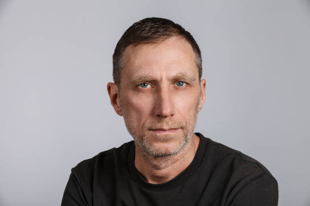 istock Beard man wearing t-shirt on light gray background. Studio shot 1309035431