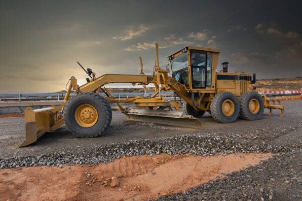 istock Excavator machine leveling the ground at a road construction site 1309036434
