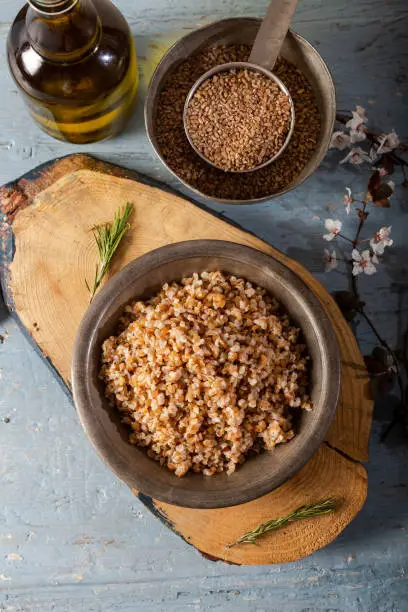 Einkorn, Triticum Monococcum, Siyez wheat bulgur.Bulgur pilaf made with siyez bulgur in plate on wooden background.