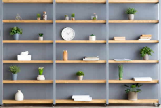 istock Shelves with plants in pots, accessories, decor elements and clock on gray wall background 1309037837