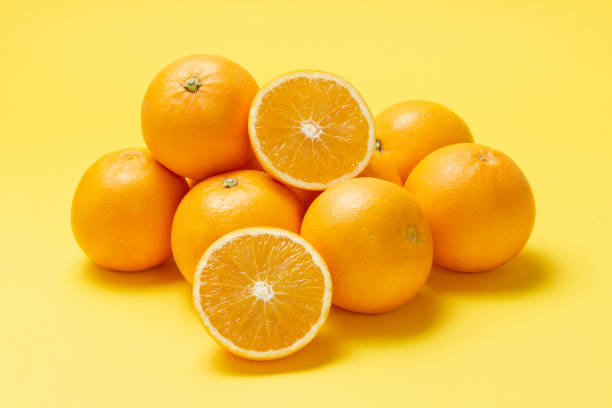 istock oranges and kiwi isolated on light yellow
 background 1309037960