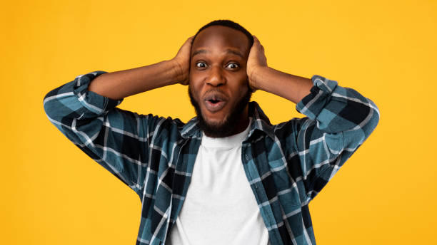 istock Surprised African Guy Touching Head Looking Posing Over Yellow Background 1309038031