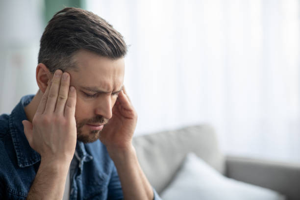 istock Closeup of middle-aged man suffering from headache 1309038199