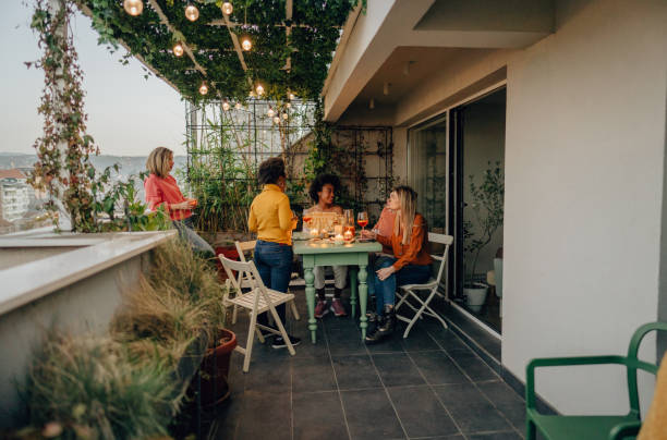 istock Girlfriends enjoying wine on the open terrace 1309038836