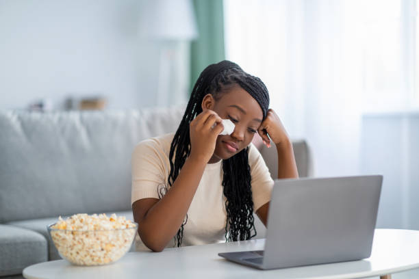 istock Upset black lady watching melodrama and crying 1309038956