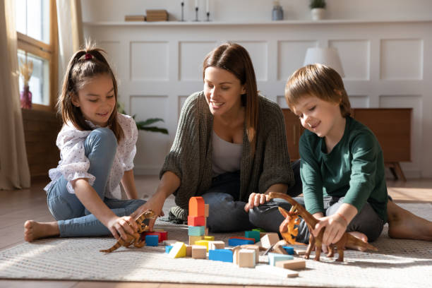 istock Caring single mother play with two children at home 1309039195