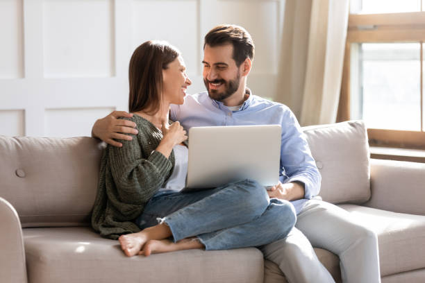 istock Happy couple relax on sofa using laptop 1309039235
