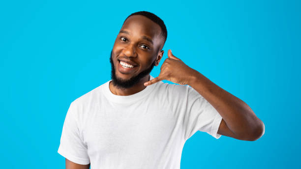 istock African Guy Showing Call Me Gesture Standing Over Blue Background 1309039551