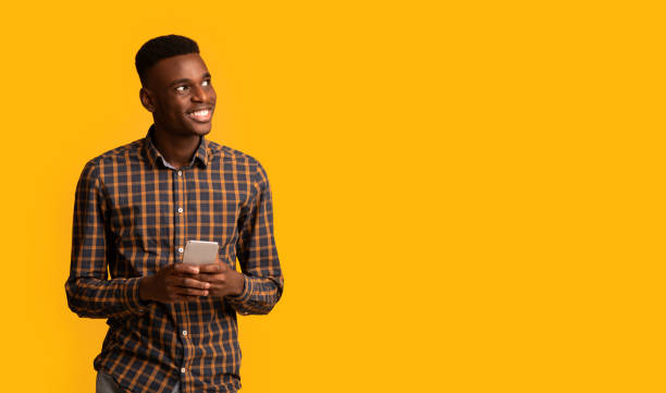 istock Mobile Offer. Excited Cheerful Black Guy Holding Smartphone And Looking Aside 1309040090