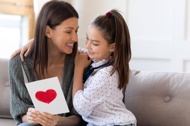 istock Caring daughter greeting excited mom with birthday 1309040279