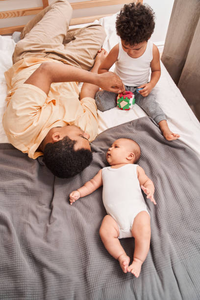 istock Father playing with his beloved son while laying at the bed 1309045043