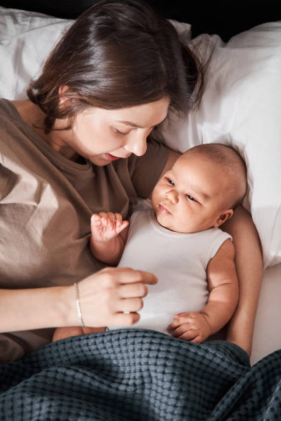 istock Mother playing with her little newborn baby while spending time together 1309045091