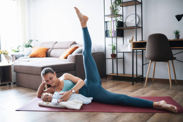 istock Mother making pilates at home with her little baby. 1309046855