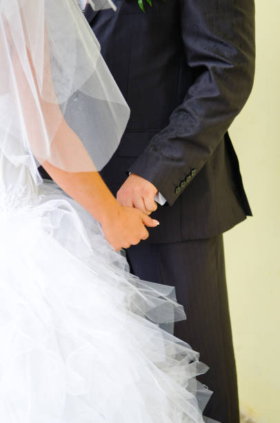 istock People's hands on the wedding day. 1309048877