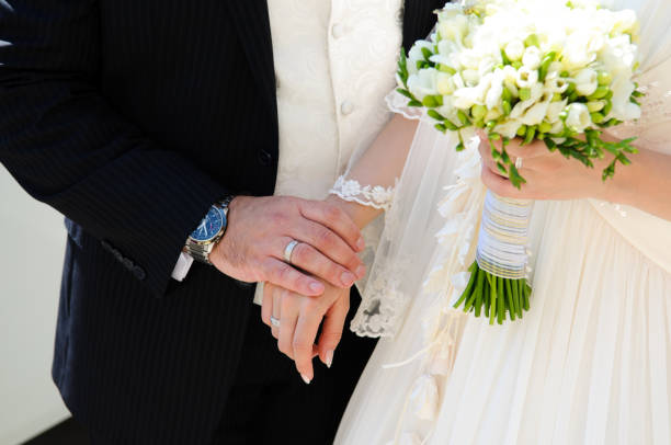 istock People's hands on the wedding day. 1309048986