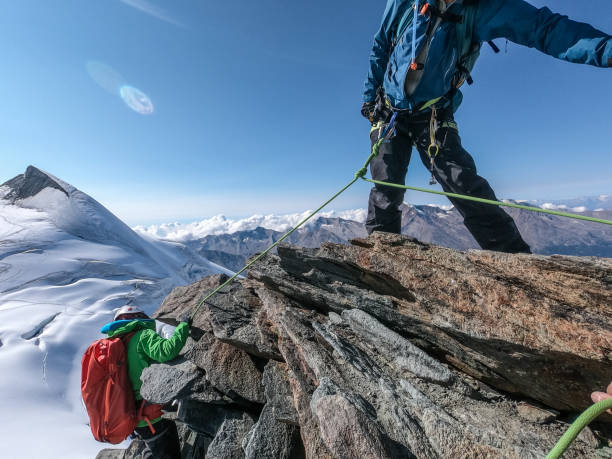 istock Climbing in high altitude mountains with rope. Winter landscape 1309049555