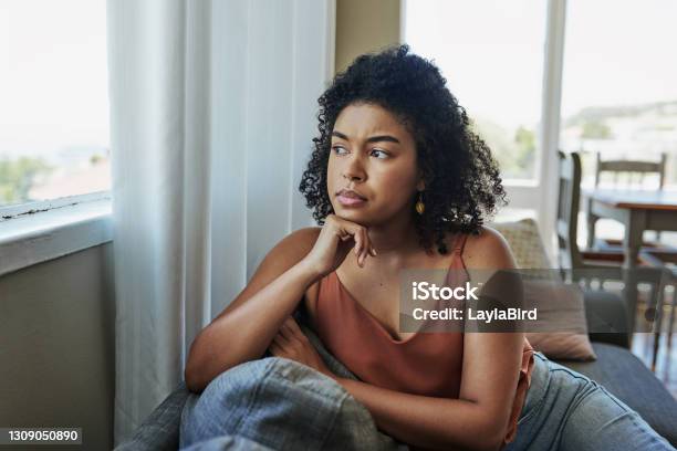Sitting With The Worries Of An Uncertain Future Stock Photo - Download Image Now - Women, One Woman Only, Contemplation