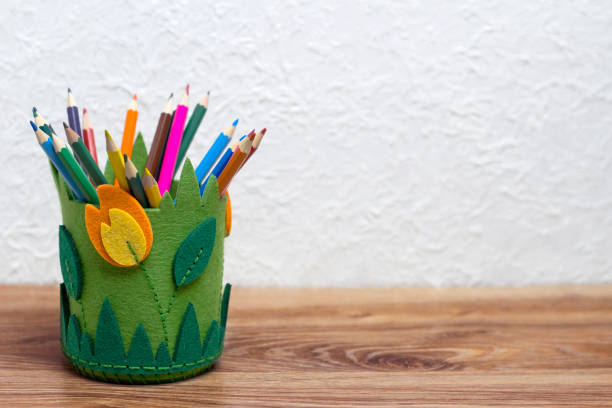 DIY fabric pencil holder. Office on a wooden table.