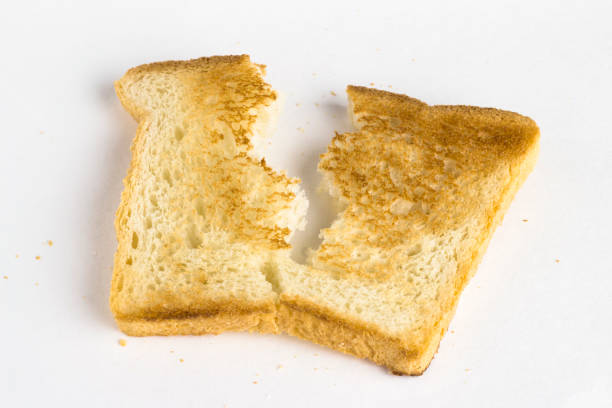 istock Broken piece of toast on a light background. 1309052725