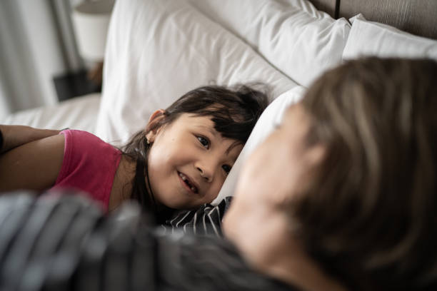 istock Mother waking up daughter at home 1309053096