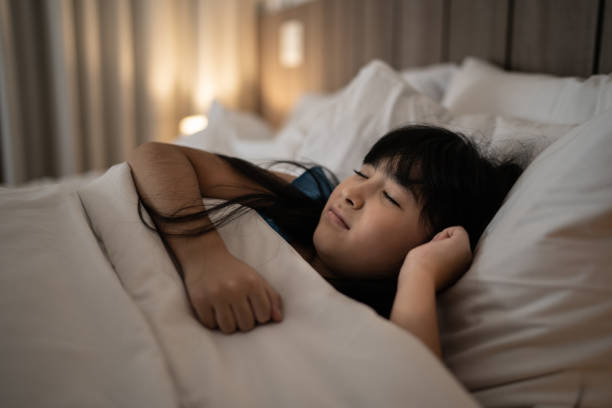 istock Cute Asian girl sleeping at home 1309053891