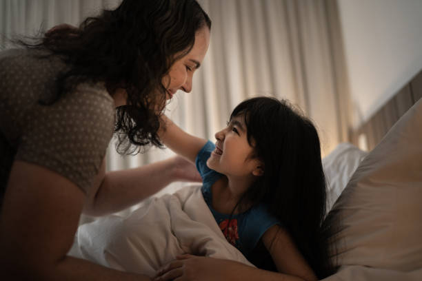 istock Mother embracing daughter in bed 1309054032