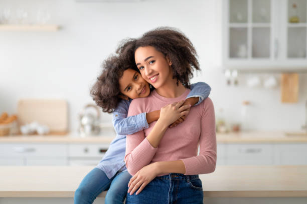 istock African American daughter hugging her smiling mum from the back 1309054522