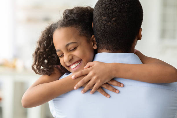 istock Happy black girl hugging her dad, closeup 1309054587