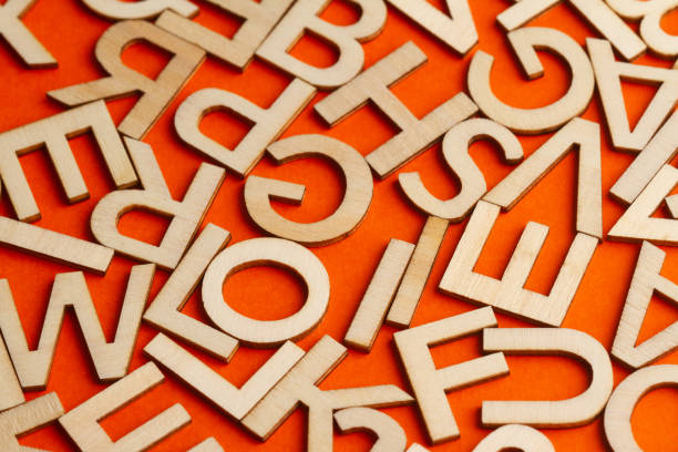 istock wooden cut alphabet letters on orange background 1309055015