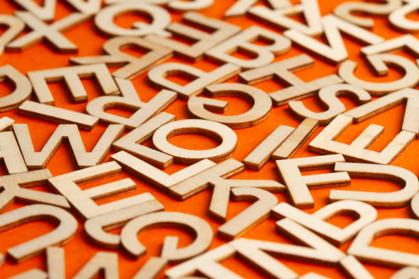 istock wooden cut alphabet letters on orange background 1309055023