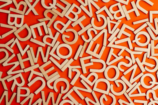 istock wooden cut alphabet letters on orange background 1309055037