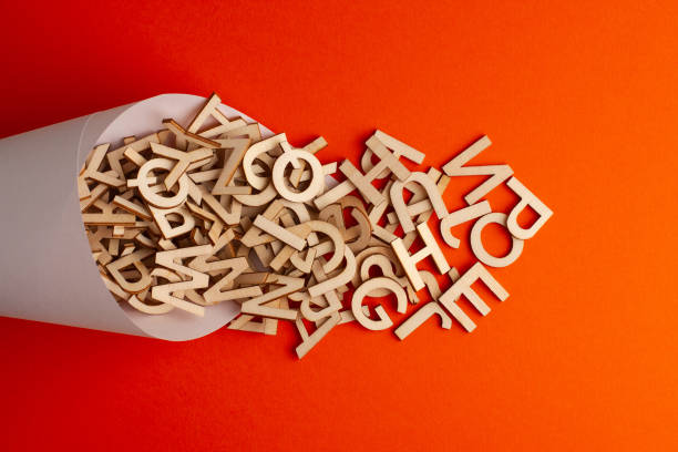istock wooden alphabet letter spilled from a paper cone 1309055662