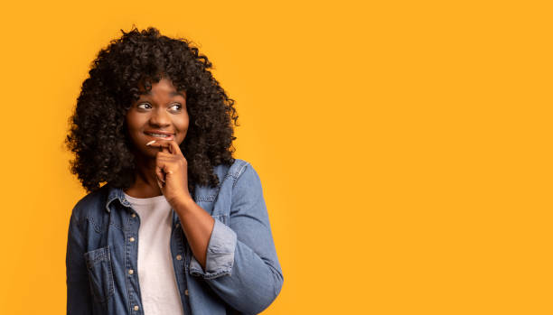 istock Curious african american young woman looking at empty space, panorama 1309056253