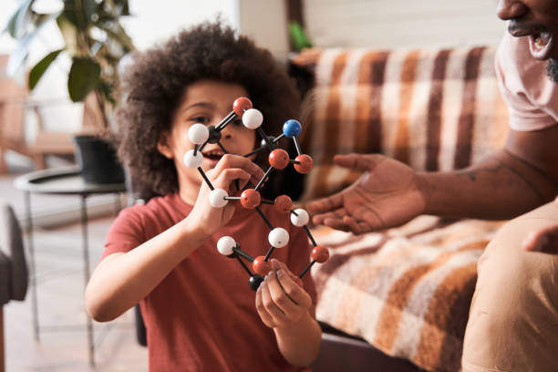 istock Optimistic boy and his father playing at the educational game 1309057345
