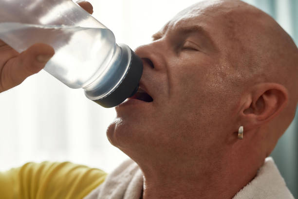 istock Middle aged caucasian man drinking from sport bottle 1309057398