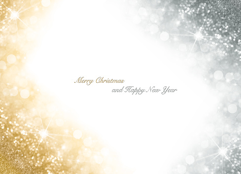 Christmas card with bright gold and silver sparkly over white background with copyspace for your seasonal greeting