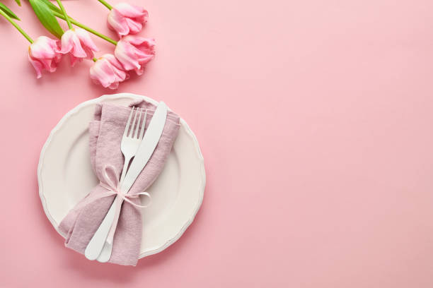 istock Easter table setting with floral decor on pink table. Elegance dinner. Mock up. Top view. 1309059208