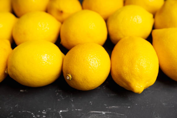 istock Ripe bright lemons on the dark rustic background. Selective focus. Shallow depth of field 1309059868